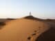 Omani man walking on dunes © Ministry of Heritage Tourism Sultanate of Oman